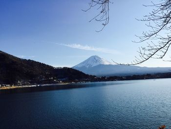 Scenic view of lake by mountains against sky