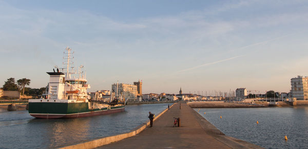 Entrance to the port of les sables d'olonne at dawn between the two piers
