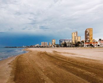 Scenic view of beach against sky in city