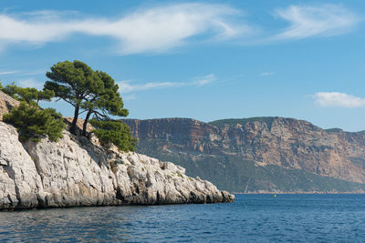 Scenic view of sea and mountains against sky