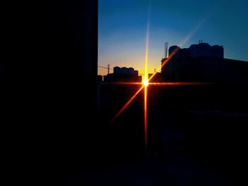Silhouette built structure against clear sky at sunset