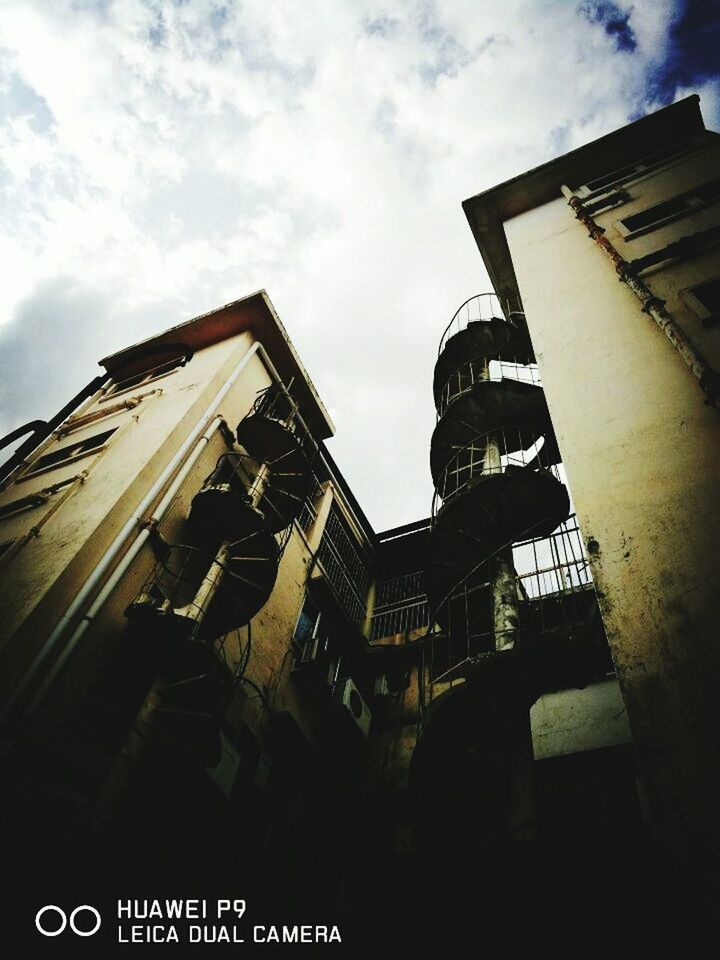 LOW ANGLE VIEW OF TOWER AGAINST CLOUDY SKY