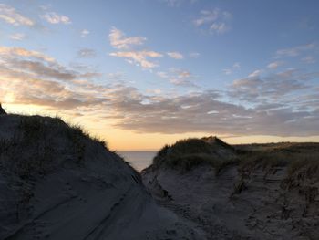 Scenic view of snow field against sky during sunset