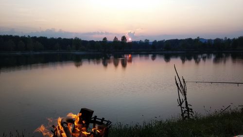 Scenic view of lake against sky during sunset