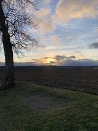 Scenic view of field against sky during sunset