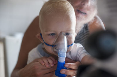 Portrait of boy inhaling