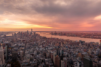 High angle view of modern buildings against sky during sunset