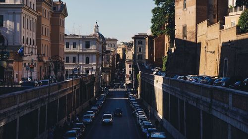 Cars on road amidst buildings in city