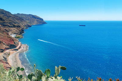 High angle view of sea against clear blue sky