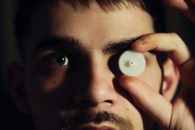 Cropped hand of woman holding mask
