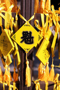 Close-up of yellow decorations hanging