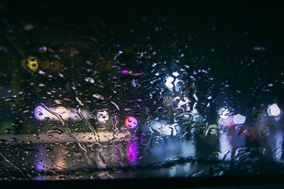 Close-up of illuminated lights against sky at night