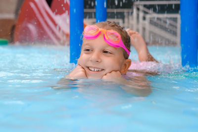 Portrait of boy swimming in pool