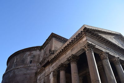 Low angle view of old building against blue sky