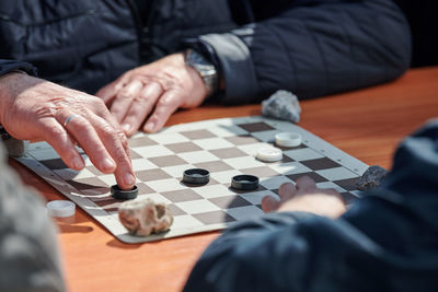 Midsection of man playing chess