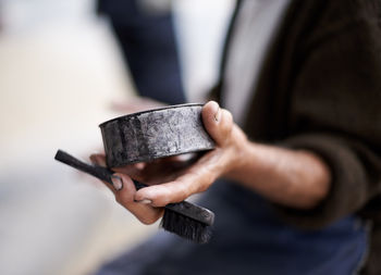 Midsection of man using mobile phone