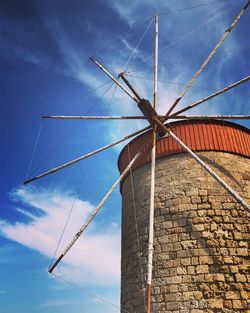 Low angle view of windmill against sky