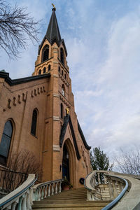 Low angle view of cathedral against cloudy sky