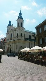 Street in front of old town against sky