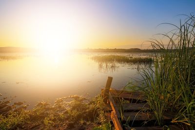 Scenic view of lake against sky during sunset