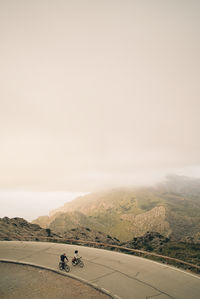 High angle view of male and female friends cycling on road