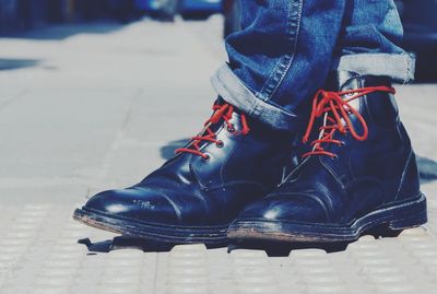 Low section of woman standing on tiled floor