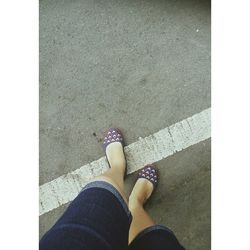 Low section of woman standing on tiled floor