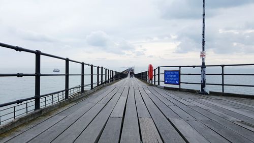 Pier over sea against sky