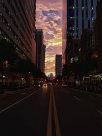 View of city lit up at sunset