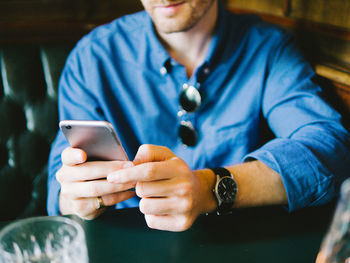 Close-up of man using mobile phone