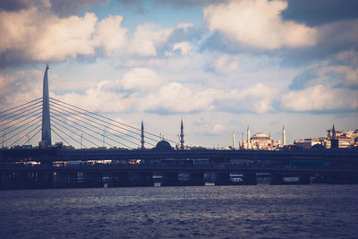 View of bridge over sea against cloudy sky