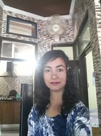 Portrait of a smiling young woman at home