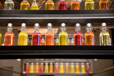 Close-up of various bottles on shelf at store
