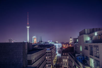 Fernsehturm in city against sky at night