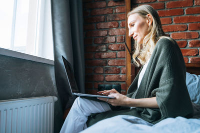 Young woman using laptop at home