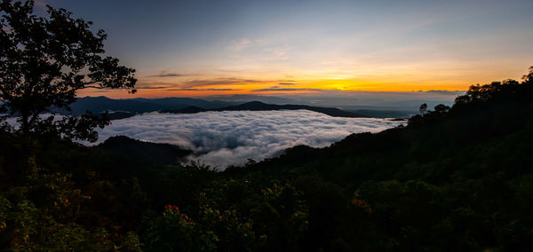 Scenic view of silhouette mountains against sky during sunset