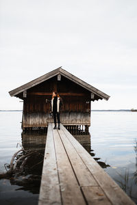 Rear view of man standing on pier