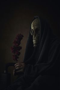 Midsection of person sitting on chair at home