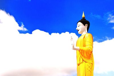 Low angle view of statue against temple against sky