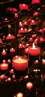 Illuminated tea light candles in temple
