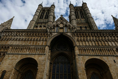 Low angle view of cathedral against cloudy sky