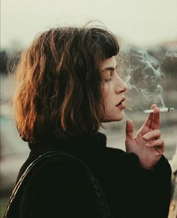 Portrait of woman smoking cigarette