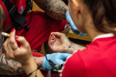 High angle view of doctor examining patient at home