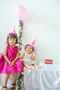 Portrait of smiling girl with pink balloons