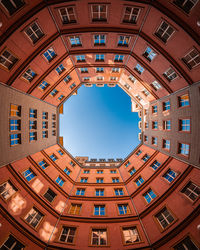 Low angle view of buildings against blue sky