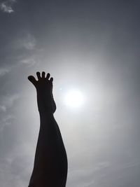 Low angle view of silhouette person against sky