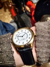 Close-up of hand holding clock