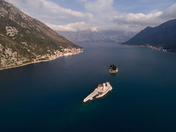 High angle view of man standing by sea against sky