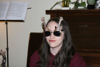 Portrait of woman wearing sunglasses at home