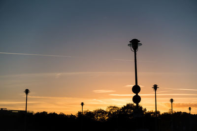 Low angle view of street light against sky during sunset